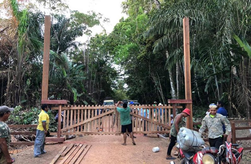 Residents of Surama construct and close the gate to their village in light of COVID-19 in the country.