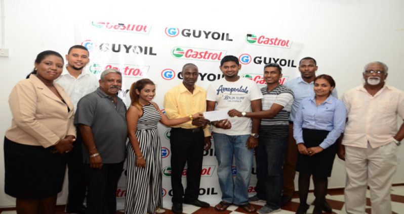 GuyOil managers and representatives stand with the drivers for a photo opportunity. (Adrian Narine photo)