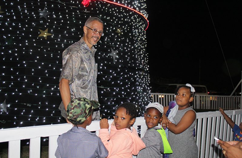 A few eager children gathered for a photo with Minister of Business Dominic Gaskin