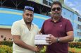 Ameer Rahaman, left, of RHCCC, receiving the balls from Anil Beharry.