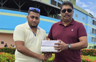 Ameer Rahaman, left, of RHCCC, receiving the balls from Anil Beharry.