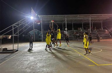 Raiders Action between attacking Raiders’ player in center with black, sandwiched by two Royals defensive players in yellow