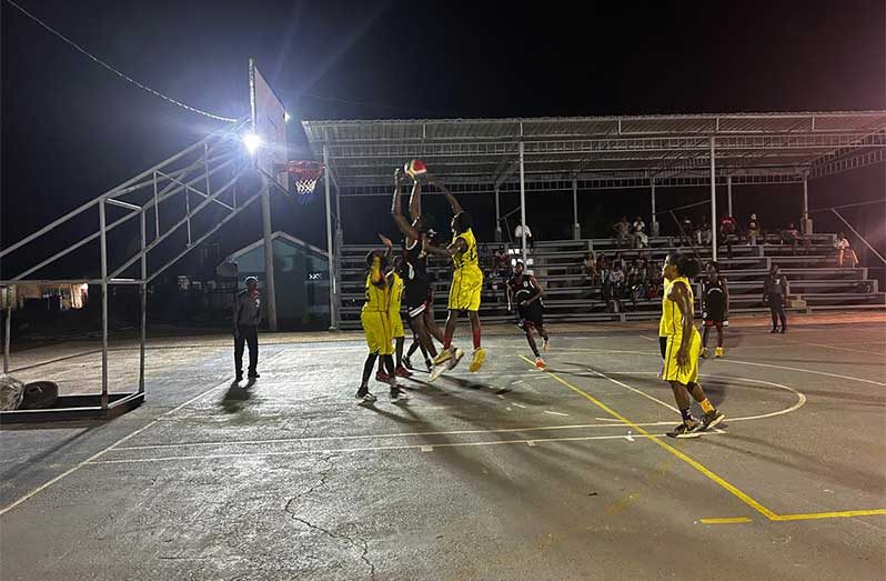 Raiders Action between attacking Raiders’ player in center with black, sandwiched by two Royals defensive players in yellow