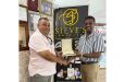 Tournament Director Raj Singh, left, receives the Player-of-the-Tournament prize from Steve Naraine, owner of Steve’s Jewellery