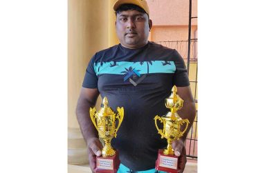 CWC Bomb Squad head Ryan Ramdass poses with the two trophies..