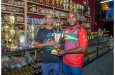 Ramesh Sunich (left) hands over one of the trophies to Yusuf Ali of FL Sport.