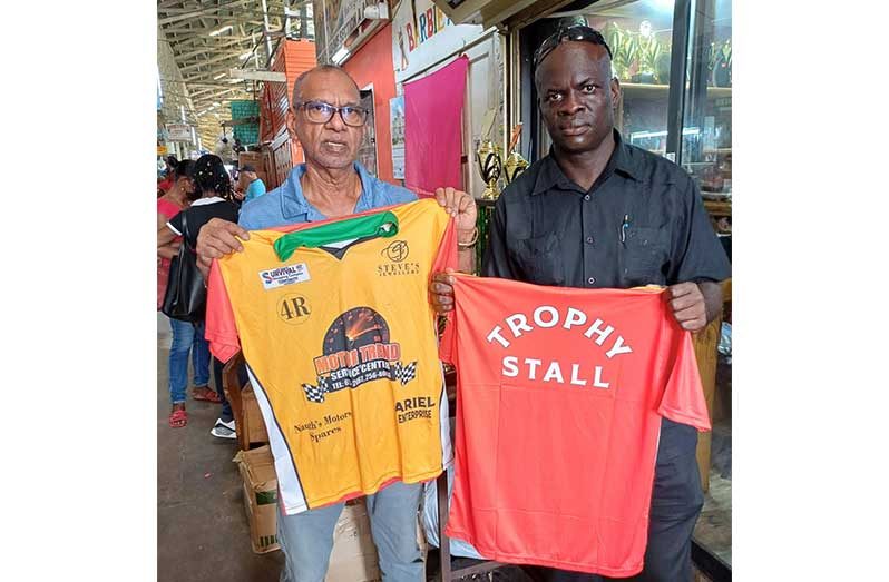 Managing Director of Trophy Stall, Ramesh Sunich (left), and Samuel Kingston display the Trophy Stall Lions uniforms
