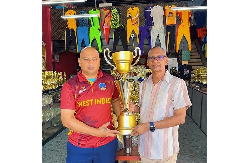 Ramesh Sunich(right), proprietor of Trophy Stall, hands over one of the trophies to a representative of Big Man Cricket