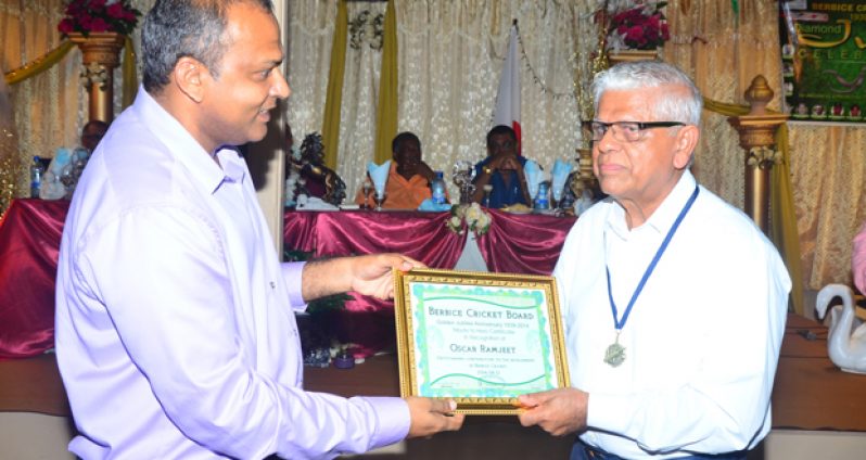 Florida-based Guyanese Oscar Ramjeet (right) accepts his Tribute to Heroes Certificate from Minister of Sport Dr Frank Anthony, during the hosting of the BCB’s Diamond Jubilee Anniversary Dinner last Sunday night. (Photo by Adrian Narine)