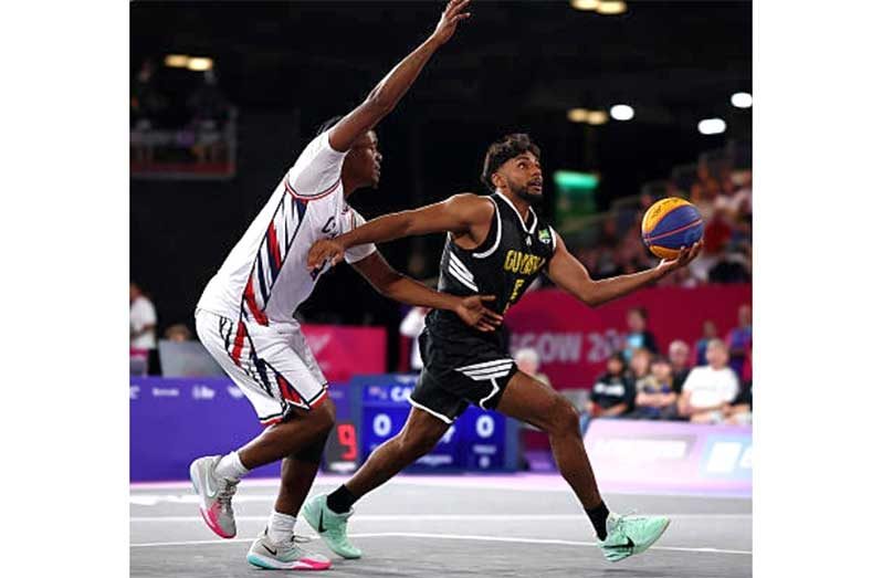 Guyana’s Anish Ramlall (right) drives to the basket against the Cayman Islands at the Commonwealth Games (Getty Images)