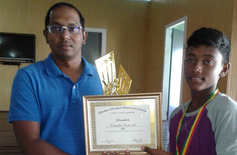 BCB treasurer Dr Cecil Beharry presents gifts to Rampertab Ramnauth.