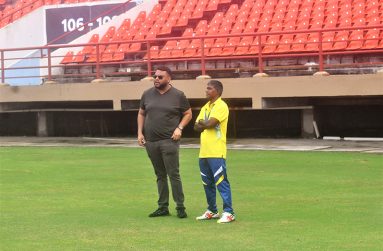 Coach Rampat (left) chats with Guyana U-13 coach Latchman Yadram (Sean Devers photo)