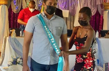 Minister Charles Ramson is inducted as Patron by Youth Ambassador Denica Henry.