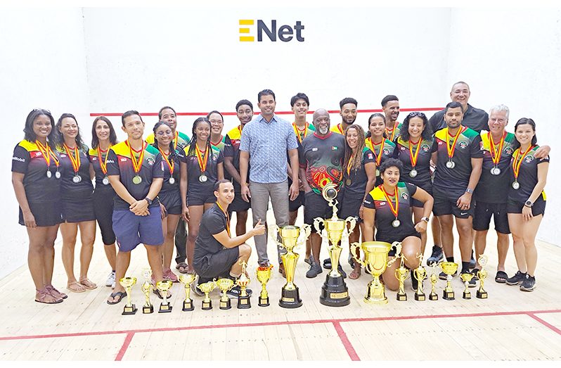 Sports Minister Charles Ramson (centre), Coach Ince (to his left) and GSA president David Fernandes (thi rd from left) with the victorious Guyana team (Sean Devers photos)