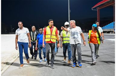 Minister Charles Ramson Jr. (centre) and Minister Steven Jacobs (far left) lead the inspection team at the synthetic track