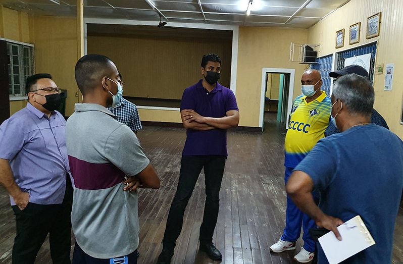 Sport Minister Charles Ramson Jr. (centre) in discussion with members of the Enmore Community Centre. At left is President of the Guyana Cricket Board, Bissoondyal Singh.(Photo-courtesy of Newsroom).
