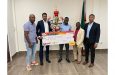 Bent Street captain, Adrian Aaron receives his team’s One Guyana Futsal spoils from Minister Charles Ramson Jr. and members of the Kashif and Shanghai Organisation