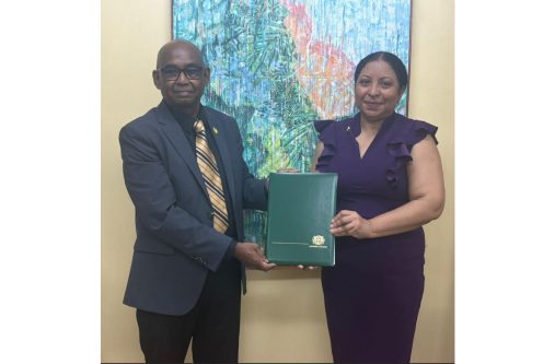 Vice-Chancellor of the University of Guyana, Prof Paloma Mohamed Martin, presenting the instruments of office to Prof. Randy Persaoud
