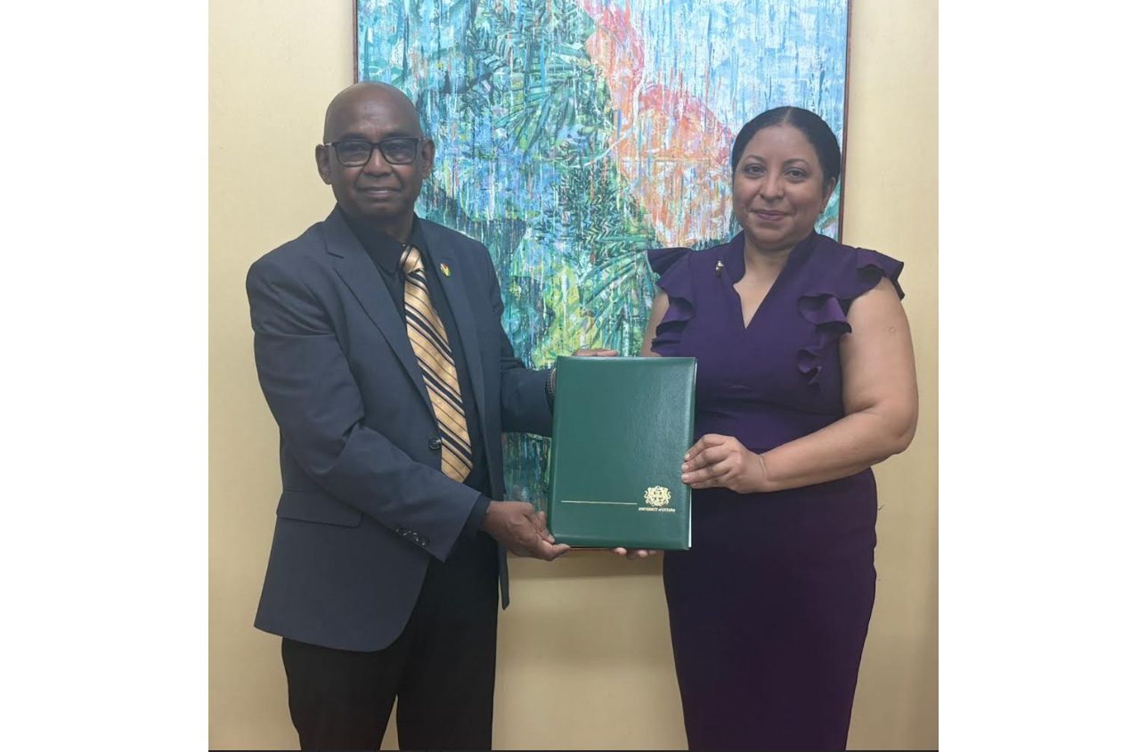 Vice-Chancellor of the University of Guyana, Prof Paloma Mohamed Martin, presenting the instruments of office to Prof. Randy Persaoud