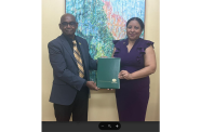 Vice-Chancellor of the University of Guyana, Prof Paloma Mohamed Martin, presenting the instruments of office to Prof. Randy Persaoud