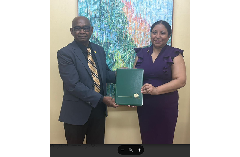 Vice-Chancellor of the University of Guyana, Prof Paloma Mohamed Martin, presenting the instruments of office to Prof. Randy Persaoud