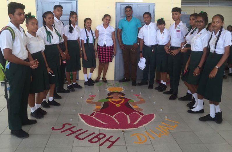 Students from the Johanna Cecilia Secondary standing in front of their Rangoli