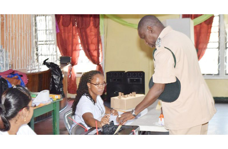 FLASHBACK: A senior prison officer drops his ballot paper in the box during the 2016 LGE