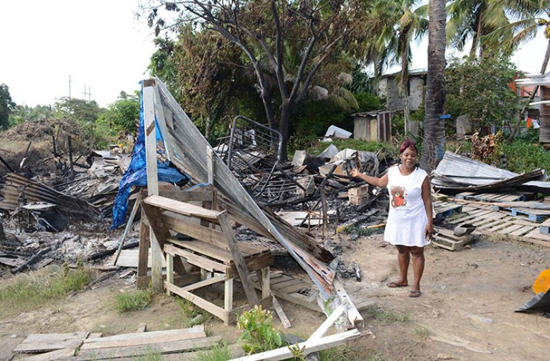 Yonette Roberts points to what remains of the house in which  she and her family once lived