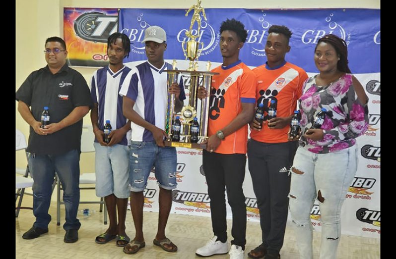 From left, GBI’s Raymond Govinda, Deon Alfred, Kelsey Benjamin, Nicholas McArthur, Ryan Hackett and Jackie Boodie of Petra pose with the winners’ trophy. (Stephan Sookram photo)