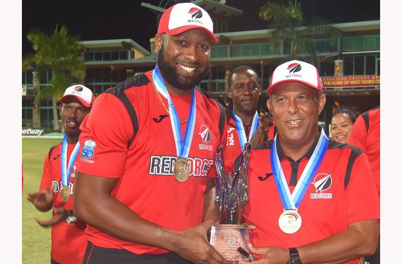 Red Force captain Kieron Poweel (left) and Head coach celebrate with the Sir Clive LLoyd Super 50 trophy