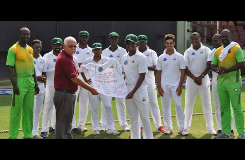 Guyana Jaguars skipper Leon Johnson presented the signed jersey to Joseph ‘Reds’ Perreira, in the presence of his players, coach Esaun Crandon and Chairman of Selectors Rayon Griffith.