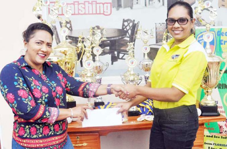 Bibi Samaroo of Regal Stationery and Computer Centre and Regal Sports presents the cheque to GSCL Inc secretary, Telesha Ousman.