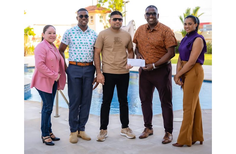 Azruddin Mohammed (centre) hands over Team Mohamed’s contribution to Regatta Committee Chairman, Mr. Kenneth Williams in the presence of others.