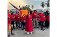 Former Member of Parliament and prominent legal professional Geeta Chandan-Edmond waves for flag high with supporters at the meeting at Murphy Dam, Rosignol