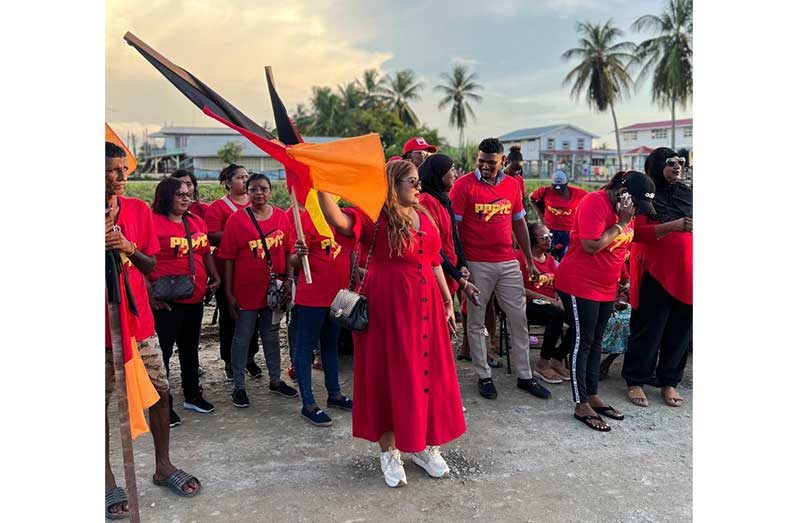 Former Member of Parliament and prominent legal professional Geeta Chandan-Edmond waves for flag high with supporters at the meeting at Murphy Dam, Rosignol