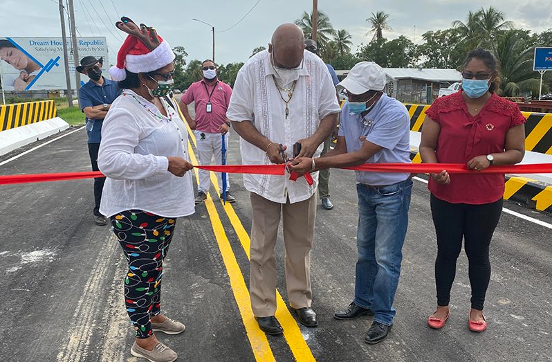 Minister of Public Infrastructure, Bishop Juan Edghill (second from left) cuts the ribbon
to officially open the new Riverstown bridge. Also pictured are Region Two Chairperson,
Vilma De Silva (right) and Regional Vice-Chairman, Humace Odit (second from left)
