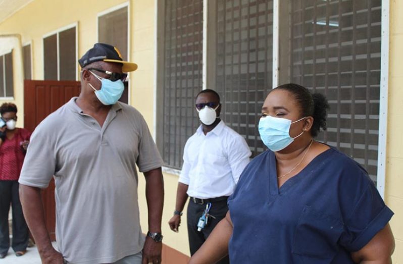 Regional Executive Officer, Orrin Gordon, in deep conversation with Dr Tracey Bovell, Emergency Medicine Specialist at GPHC, while Medical Superintendent at Linden Hospital Complex, Dr Joseph London, pays rap attention as they tour the isolation facility at Wismar hospital.