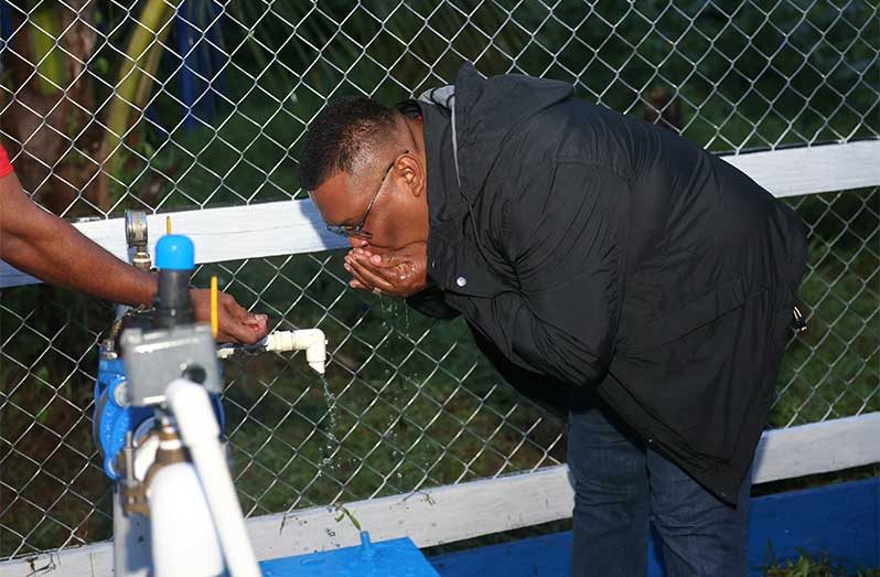 Regional Chairman, Brentnol Ashley, takes a refreshing sip from the Hobodeia water supply system
