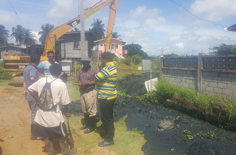 Regional officials on a site visit at ongoing emergency desilting works at Bath Settlement, West Coast Berbice