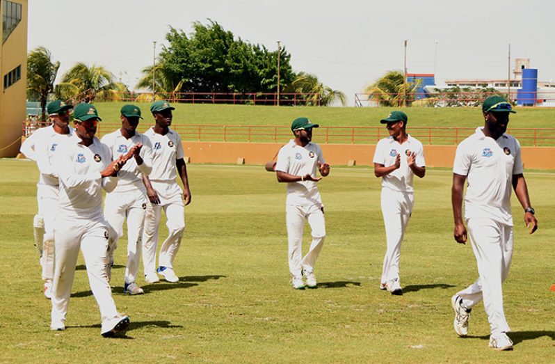 Raymon Reifer leads his teammates off the field after claiming 5-40. (Adrian Narine photos)