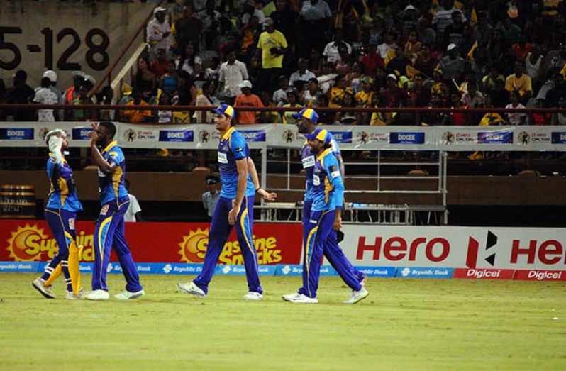 Raymond Reifer and teammates after he claimed his five-wicket haul. (Adrian Narine photos).