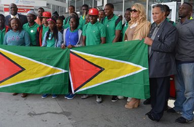 The eighteen teenagers from the Fort Wellington Secondary School stand proudly with the Guyana Flag at the John F. Kennedy International Airport, New York. Also in photograph are: Karen Kraus, Chief Operations Officer Dynamic Airways, Captain Gerry Gouveia, and Rickford Burke Chairman of Guyana’s 50th Independence Anniversary celebrations.