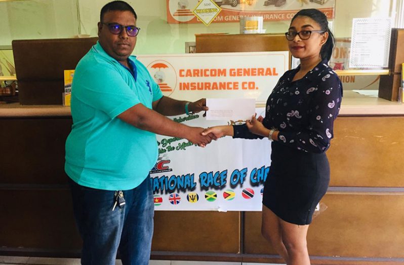 Saurica Singh (right) collects sponsorship from CARICOM insurance company’s representative.