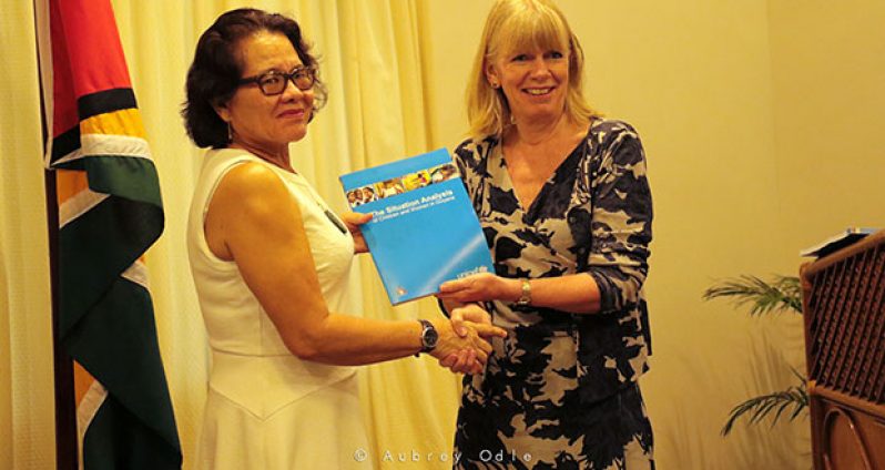 First Lady, Mrs Sandra Granger receives a copy of the report on ‘Situation Analysis (SitAn) of Children and Women by UNICEF Guyana Representative Ms. Marianne Flach  (Aubrey Odle/Ministry
of Social Protection photo)