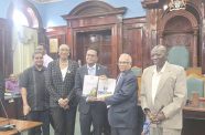 Auditor General Deodat Sharma hands over the report to Speaker of the National Assembly, Manzoor Nadir in the presence of staff of the Audit Office and Finance Secretary Sukrishnalall Pasha