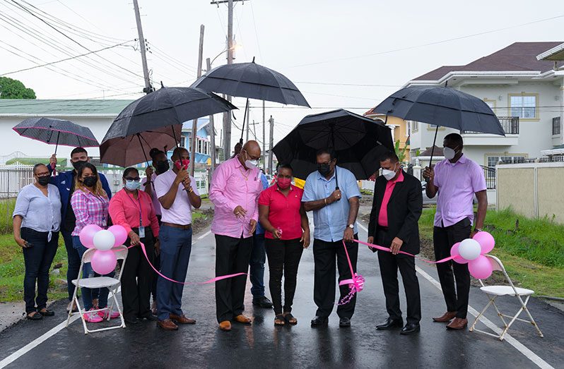 Housing and Water Minister, Collin Croal; Public Works Minister, Bishop Juan Edghill and Minister within the Ministry of Local Government and Regional Development, Anand Persaud assisted in the cutting of the ceremonial ribbon for the recommissioning of the street on Friday (Delano Williams photo)
