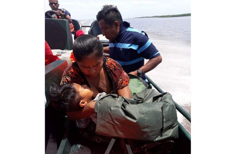 The child and parents on board the GDF vessel on their way to Kumaka on Friday (Photo courtesy the GDF)