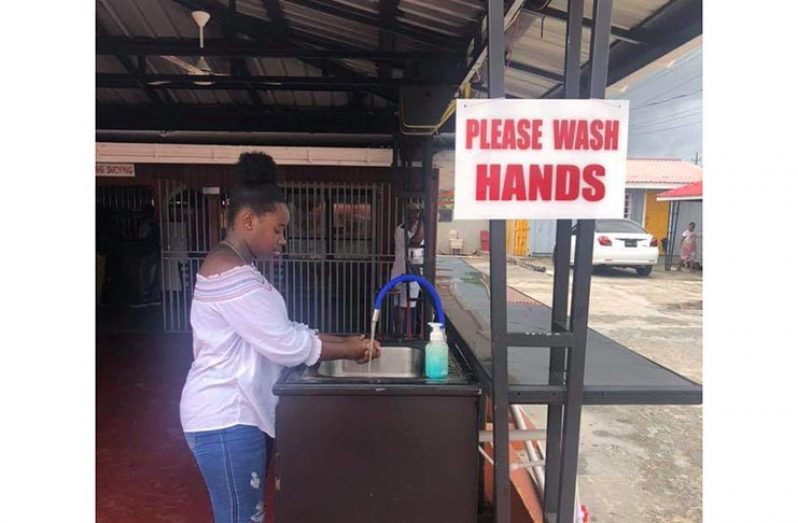 A staff member of Tropical Reflection washing her hands at a newly-installed sink at the restaurant