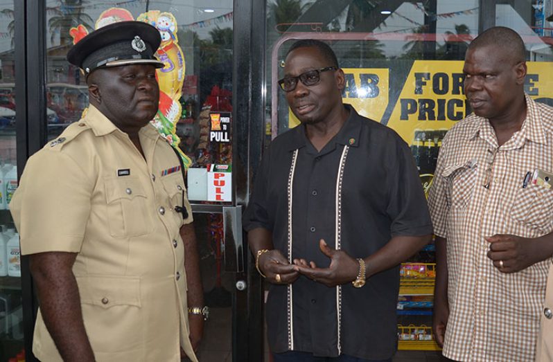 From left: Commander Stephen Mansell; Proprietor of Buxton/Friendship Fuel Station, Morris Wilson; and Chairman of the Buxton Foulis NDC, Deon Abrams discussing the results of the career  fair and future events (Photo by Rabindra Rooplall)