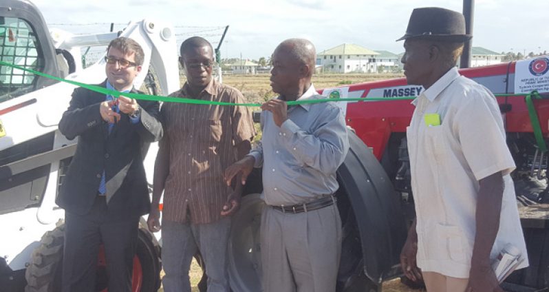 Dr Mehmet Ozkan cuts the ribbon to formally hand over the gifts from Turkey. MMA officials Godfrey Woodroffe, Aubrey Charles and Dr Ken Sealey (second, third and fourth from right) look on
